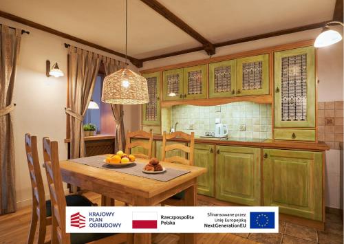 a kitchen with a table with a bowl of fruit on it at Vincent OldTown Apartments in Wrocław