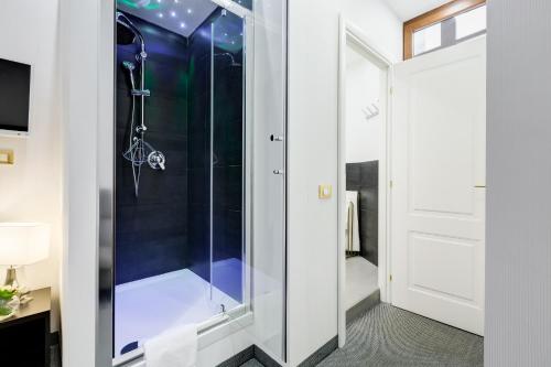 a shower with a glass door in a bathroom at Affreschi Su Roma Luxury B&B in Rome