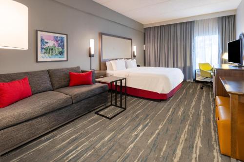 ein Hotelzimmer mit einem Bett und einer Couch in der Unterkunft Hampton Inn Commerce in Commerce