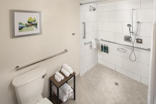 a white bathroom with a toilet and a shower at DoubleTree by Hilton Murfreesboro in Murfreesboro