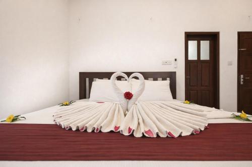 a bed with a wedding dress on it at Villa Sanitha in Ambalangoda