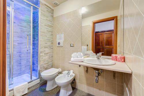 a bathroom with a toilet and a sink and a shower at Affreschi Su Roma Luxury B&B in Rome