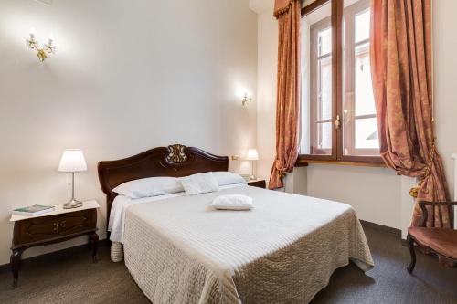 a bedroom with a bed and a window at Affreschi Su Roma Luxury B&B in Rome