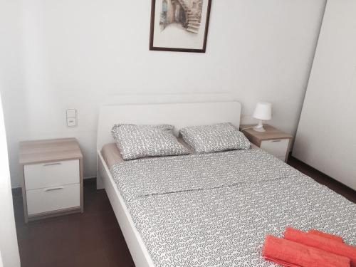 Camp Nou Apartment WiFi في برشلونة: غرفة نوم عليها سرير ووسادتين