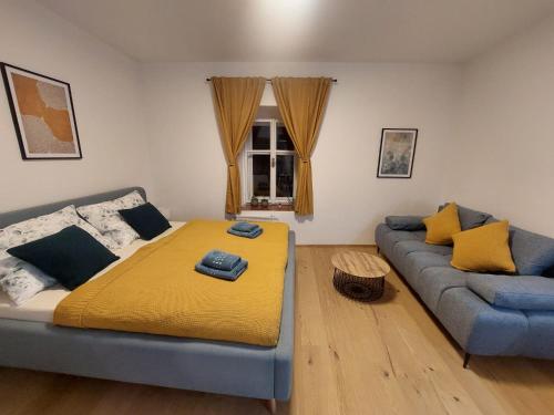 a living room with a bed and a couch at Vocell in Kutná Hora