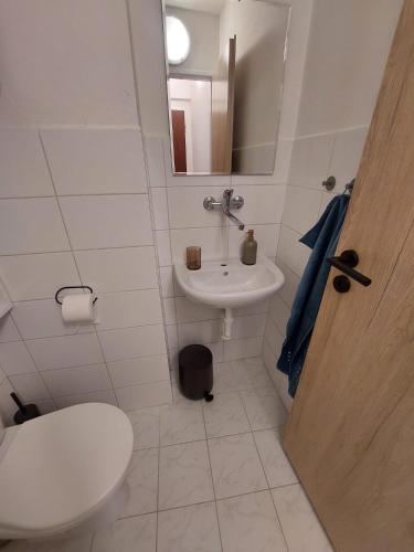 a bathroom with a toilet and a sink at Vocell in Kutná Hora