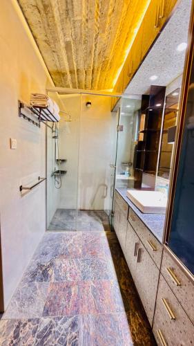 a bathroom with a shower and a sink at Privee Dhaka - PRIVEE RESORT & RESTAURANT in Bholānāthpur