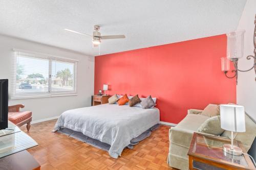 a bedroom with a bed and a red wall at Naturally Modest & Quiet in Sun City West