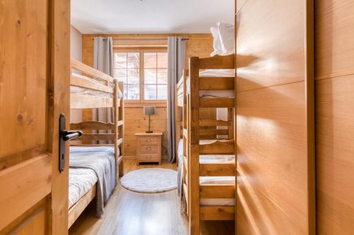 a room with two bunk beds and a ladder at Ski-in Ski-out with Chimney and view in Les Crosets