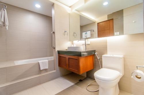 a bathroom with a white toilet and a sink at El Cielito Inn - Sta. Rosa in Santa Rosa