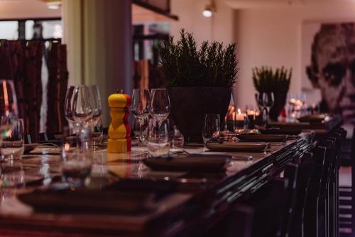 a long table with wine glasses and candles on it at Clarion Hotel Helsinki in Helsinki