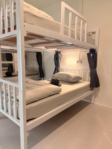 a white bunk bed in a room at Bingo Hostel Khao Sok in Khao Sok National Park