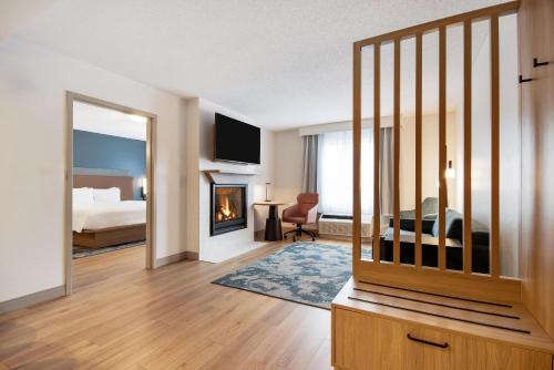 a hotel room with a bed and a fireplace at Hampton Inn Rutland/Killington in Rutland