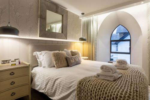 a bedroom with a bed with towels on it at Arran Shores Luxury Shorefront Apartment 3 in Lamlash