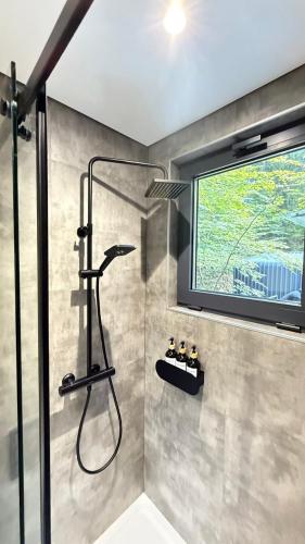 a shower in a bathroom with a window at Shypit Spa&Resort in Pilipets