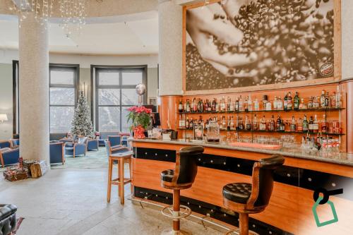 a bar in a hotel with a christmas tree at Hotiday Sauze Torre in Sauze dʼOulx