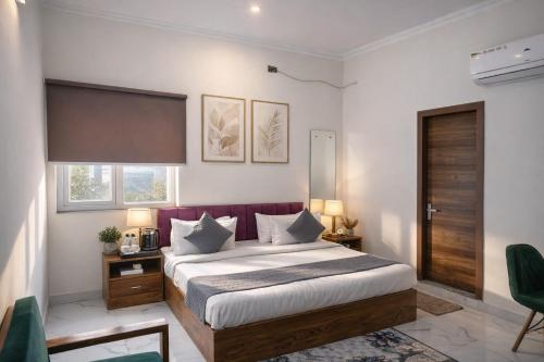 a bedroom with a large bed with a red headboard at Hotel Stayzzy Bloom in Noida