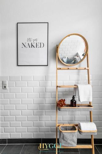 a bathroom with a towel rack and a mirror at Villa Hygge Kappeln - Design Ferienwohnungen in Kappeln