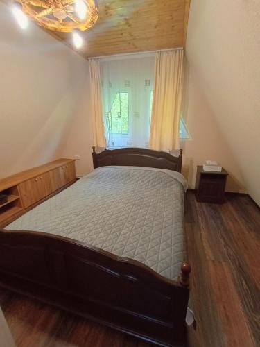 a bedroom with a large bed in a attic at Cabana Taia in Petrila