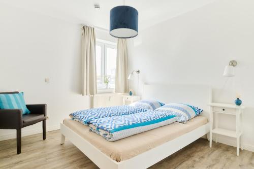 a bedroom with a bed with pillows on it at Ferienwohnung Bootsteg Moba-Travel in Priwall