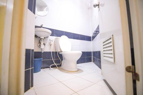 a bathroom with a toilet and a sink at Astrotel Novaliches in Manila