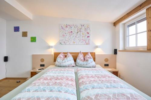 a bedroom with a bed with two pillows on it at Apartment Wenger Leogang in Leogang