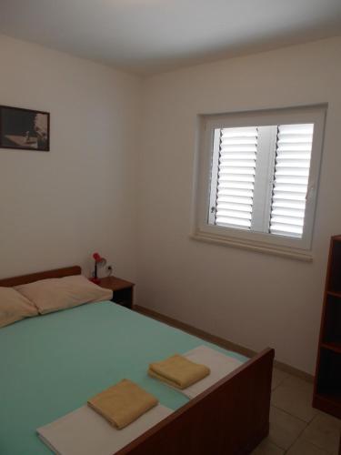 Ένα ή περισσότερα κρεβάτια σε δωμάτιο στο Apartments Dunja Hvar