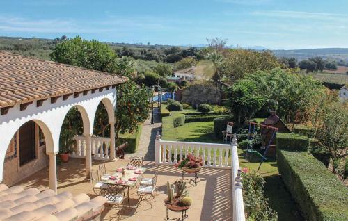 a patio with a table and chairs in a garden at Villa Rocio in Setenil