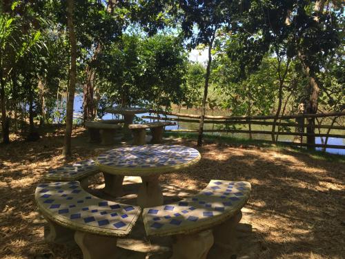 a picnic table and benches in a park at Dos Aguas in Rio Grande