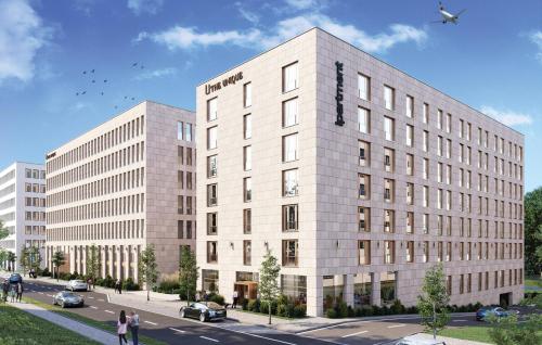 a rendering of a building with a plane flying above it at ipartment Berlin Airport HOME by Best Western in Schönefeld