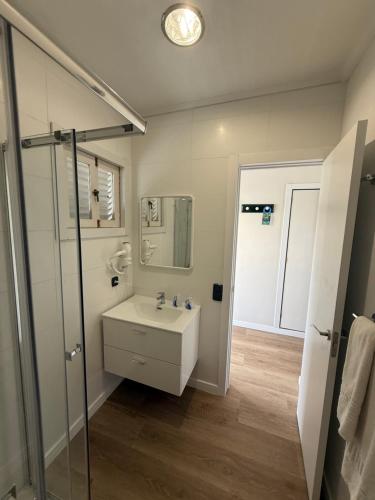 a white bathroom with a sink and a shower at Apartamentos Olympia in Playa del Ingles