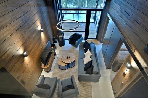 an overhead view of a living room with a table and chairs at Villa Taruilevi 3 inc Hot Tub in Levi