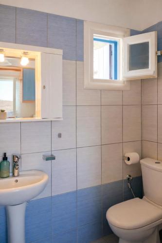 a bathroom with a toilet and a sink at Blue Calm House Kythnos in Agios Dimitrios