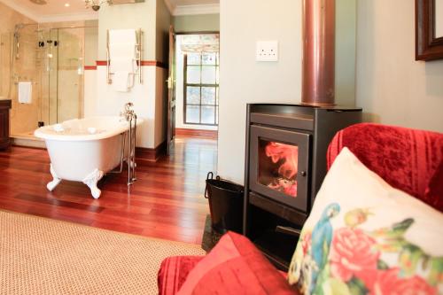 a bathroom with a bath tub and a bath tub at New England Cottage by First Private Stays in Underberg