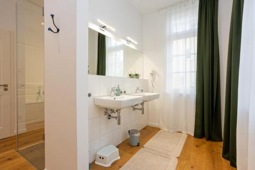 a bathroom with a sink and a mirror at Mariene Home Apartments - Am Hammer in Rösrath