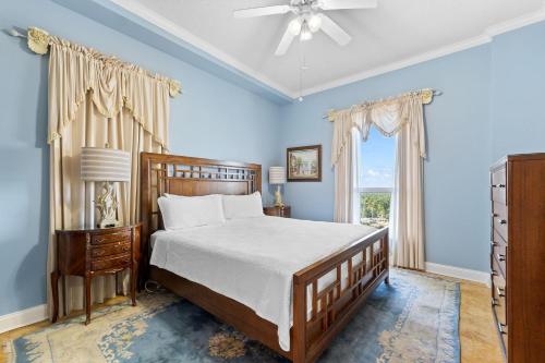 a blue bedroom with a bed and a window at La Playa 1001 in Perdido Key