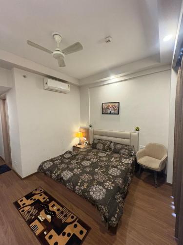 a bedroom with a bed and a table and a chair at Omaxe Air B&B in Greater Noida