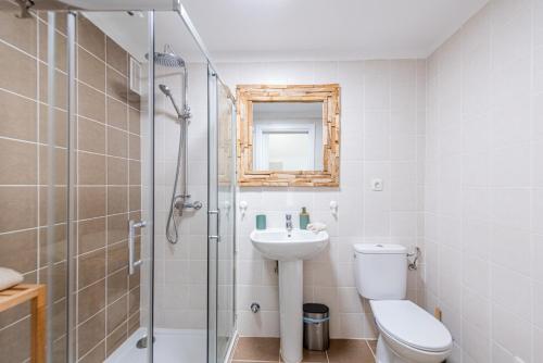 a bathroom with a toilet and a sink and a shower at Oasis in Costa Calma