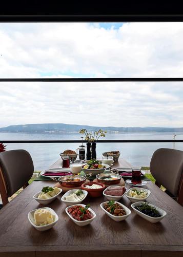 a table with many dishes of food on it at Silver Bay Club House in Urla