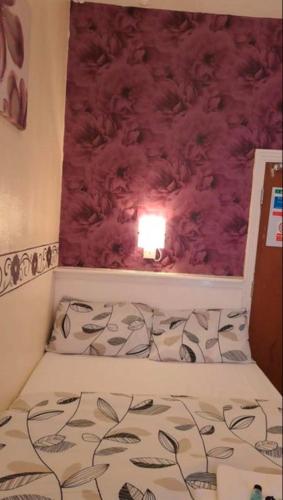 a bed in a room with a red wall at Fern Villa Hotel - Albert Road in Blackpool