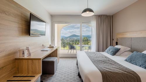 a hotel room with a bed and a window at Domaine De Saint Clair in Saint-Clair