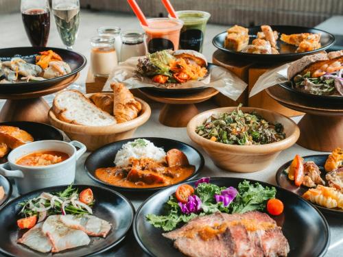 a table with many plates of food on it at The BREAKFAST HOTEL Fukuoka Tenjin in Fukuoka