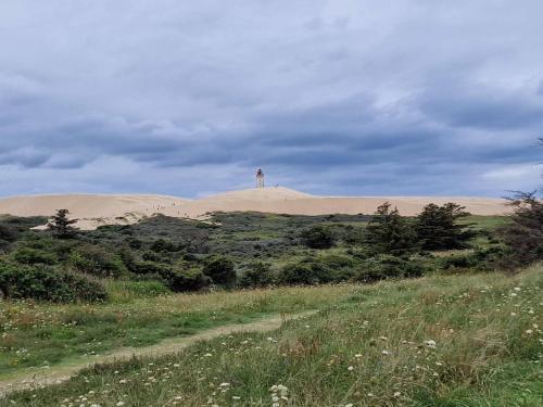 a lighthouse on top of a hill with sand dunes at 6 person holiday home in Hjørring in Hjørring
