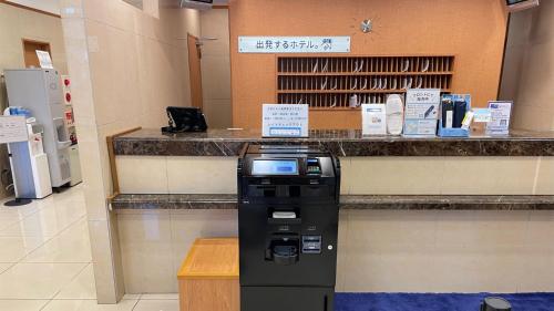 a pay station in a store with a machine at Toyoko Inn Fujisan Numazu eki Kita guchi No 1 in Numazu