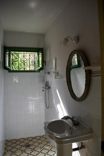 a bathroom with a sink and a mirror and a window at Cortijo Don Rodrigo in El Chorro