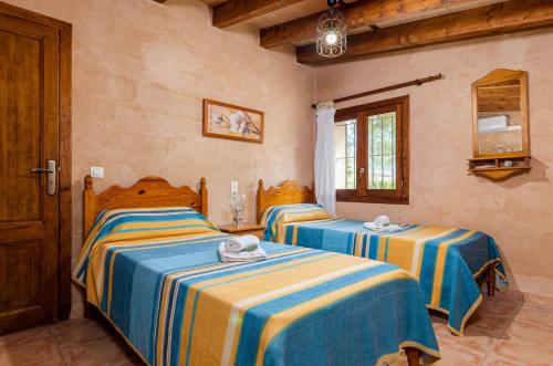a bedroom with two beds in a room at YourHouse Padri de Inca in Inca