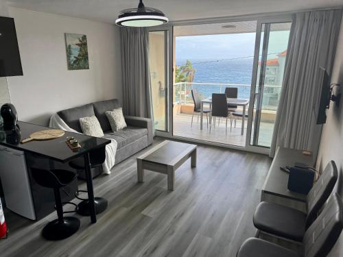 a living room with a couch and a table at Seaview Suite in Caniço