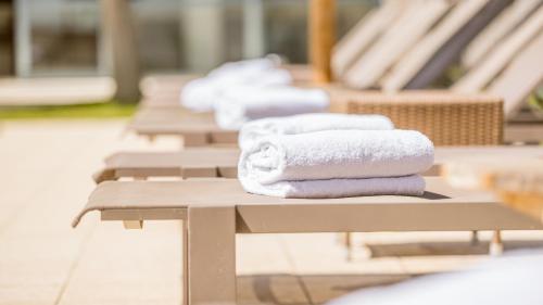 a row of towels sitting on a bench at Domaine De Saint Clair in Saint-Clair