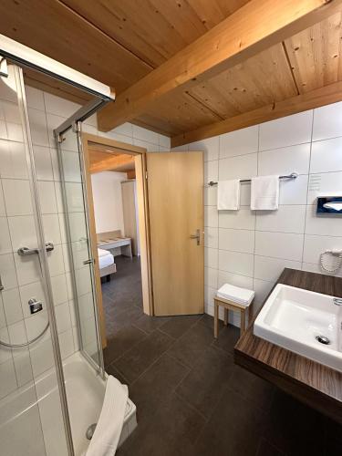 a bathroom with a shower and a sink at Chalet Gafri -Boutique B&B - comfort and hospitality - near Interlaken in Wilderswil