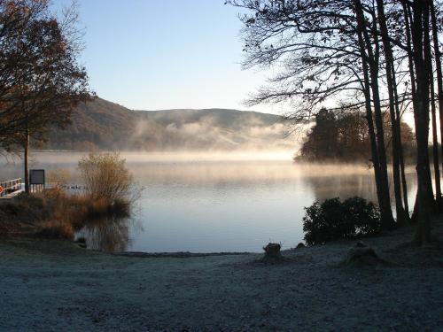 a view of a lake with fog on the water at Autumn Leaves Guest House in Windermere
